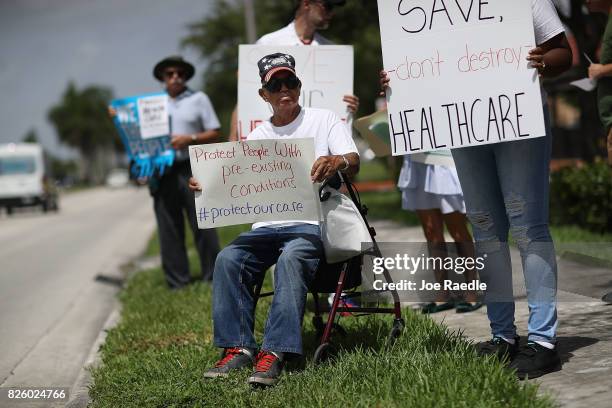 Shelton Allwood joins others for a protest in front of the office of Rep. Carlos Curbelo on August 3, 2017 in Miami, Florida. The protesters are...