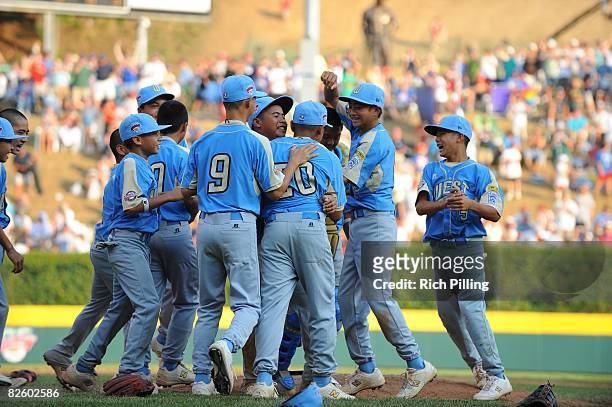Christian Donahue of the Waipio LIttle League team is greeted on the mound by teammates after winning the World Series Championship game against the...