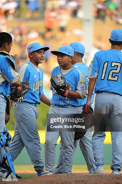 Christian Donahue of the Waipio LIttle League team stands on the mound with teammates during the World Series Championship game against the Matamoros...