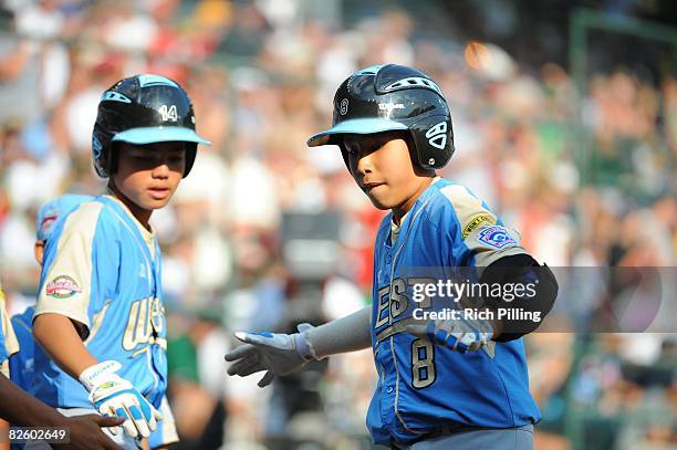 Iolana Akau of the Waipio LIttle League team scores a run during the World Series Championship game against the Matamoros Little League team at...