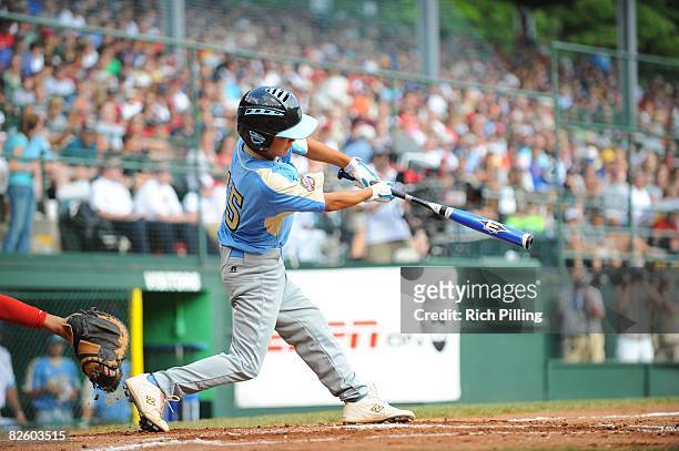 Tanner Tokunaga of the Waipio Little League team hits a home run during the World Series Championship game against the Matamoros Little League team...