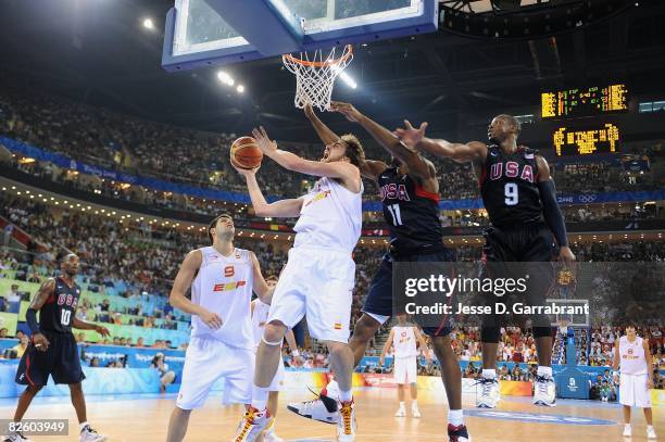 Pau Gasol of Spain lays up a shot against Dwight Howard and Dwyane Wade of the United States during the gold medal game of the 2008 Beijing Summer...
