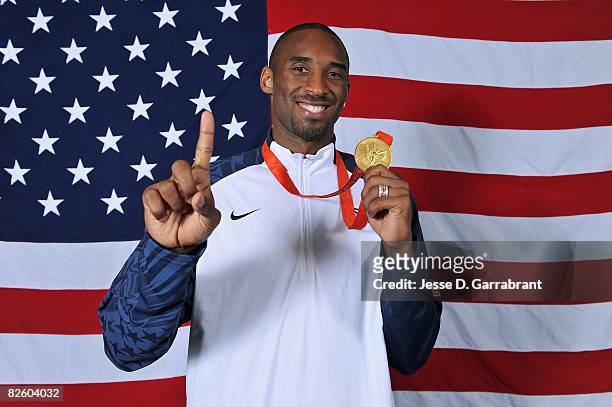 Kobe Bryant of the United States poses with his gold medal after winning the men's gold medal at the 2008 Beijing Olympic Games against Spain at the...