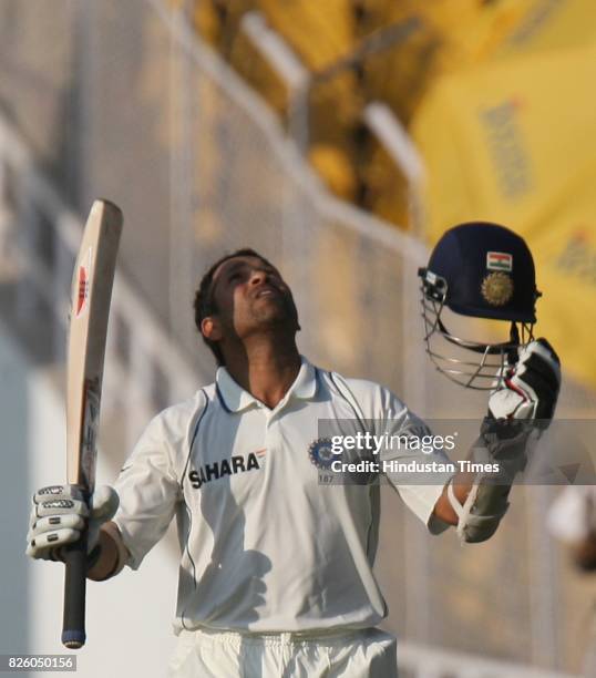 India batsman Sachin Tendulkar celebrates after his century on the fifth day of the first test match between India and Sri Lanka at Sardar Patel...