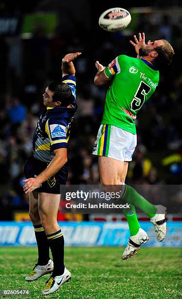 Brett Kelly of the Raiders contests a high ball with Ben Harris of the Cowboys during the round 25 NRL match between the North Queensland Cowboys and...