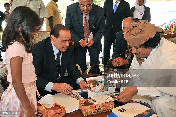 Libyan leader Moamer Kadhafi is seen during his meeting with Italian Prime Minister Silvio Berlusconi in the Mediterranean city of Benghazi, east of...