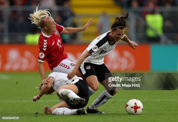 Line Jensen of Denmark is tackled by Viktoria Schnaderbeck of Austria during the UEFA Women's Euro 2017 Semi Final match between Denmark and Austria...