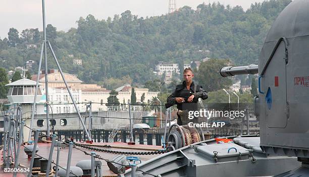 Russian seaman stands guard on a Russian warship berthed in the port city of Sukhumi on August 30, 2008. Russia called Saturday for more...