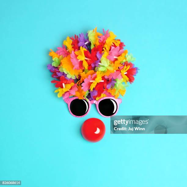 face made from flowers and sunglasses with red clown nose - clownsneus stockfoto's en -beelden