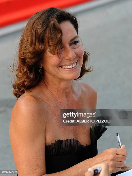 Italy's actress Monica Guerritore signs autographs before the screaming of the movie "Un Giorno Perfetto" directed by Turkey's Ferzan Ozpetek during...