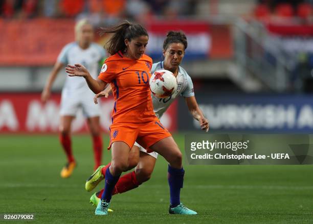 Danielle van de Donk of The Netherlands holds off pressure from Fara Williams of England during the UEFA Women's Euro 2017 Semi Final match between...