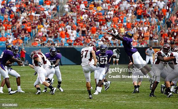 Brent Bowden of the Virginia Tech Hokies has his punt blocked by T.J. Lee of the East Carolina Pirates on August 30, 2008 at Bank of America Stadium...