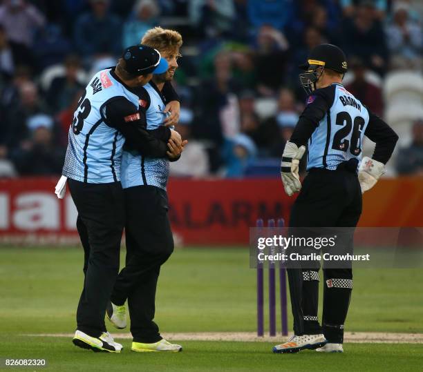 Will Beer of Sussex celebrates with Chris Nash and Ben Brown of Sussex after taking the wicket of Sam Curran of Surrey during the NatWest T20 Blast...