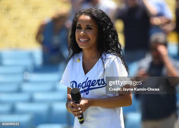 Keshia Chante sings the National Anthem before the game between the Los Angeles Dodgers and the San Francisco Giants at Dodger Stadium on July 29,...