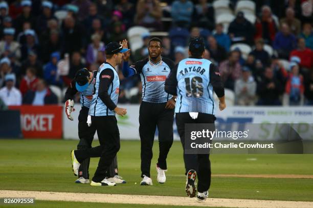 Chris Jordan of Sussex celebrates taking the wicket of Ollie Pope of Surrey during the NatWest T20 Blast match between Sussex Sharks and Surrey at...