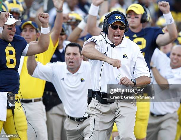 Head coach Rich Rodriguez of the Michigan Wolverines reacts after a fourth quarter touchdown in front of Nick Sheridan, Mike Barwis and David Cone...