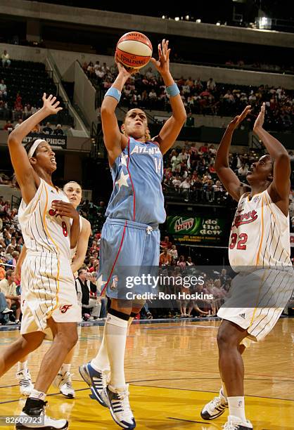 Erika de Souza of the Atlanta Dream shoots over Tammy Sutton-Brown and Ebony Hoffman of the Indiana Fever at Conseco Fieldhouse on August 30, 2008 in...