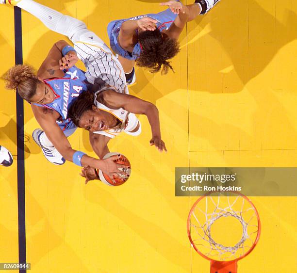 Tamika Catchings of the Indiana Fever battles Erika de Souza of the Atlanta at Conseco Fieldhouse on August 30, 2008 in Indianapolis, Indiana. The...