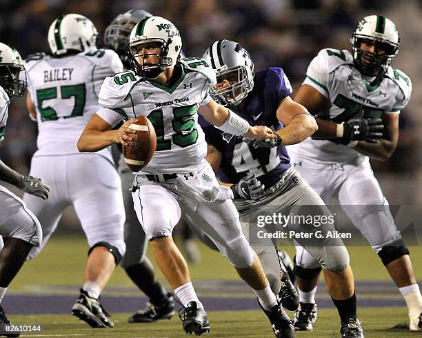 Quarterback Giovanni Vizza of the North Texas Mean Green scrambles away from pressure from linebacker Alex Hrebec of the Kansas State Wildcats in the...