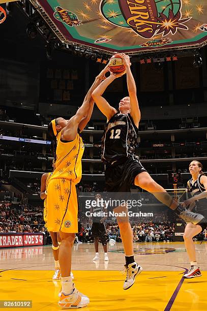Candace Parker of the Los Angeles Sparks blocks a shot during the game against Ann Wauters of the San Antonio Stars at Staples Center on August 30,...