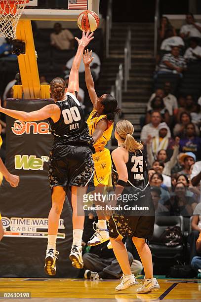 Shannon Bobbitt of the Los Angeles Sparks goes up for a shot during the game as Ruth Riley of the San Antonio Stars attempts to block the shot during...