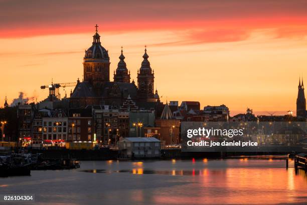 dramatic sunset, amsterdam, holland - basilica of st nicholas amsterdam stock pictures, royalty-free photos & images