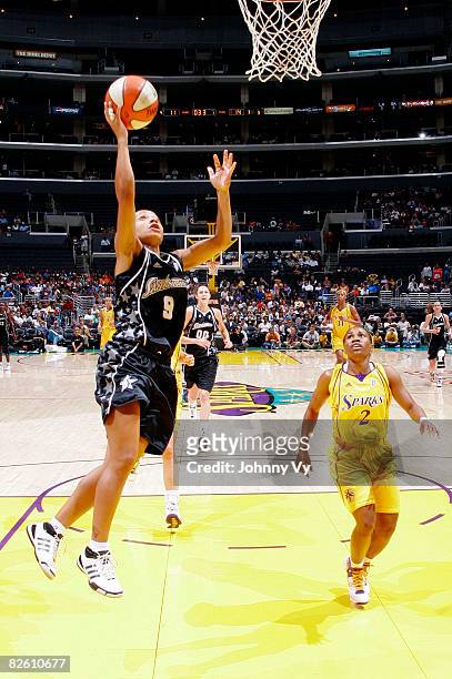 Edwige Lawson-Wade of the San Antonio Silver Stars rises for a layup while Tameka Johnson of the Los Angeles Sparks looks on during their game on...