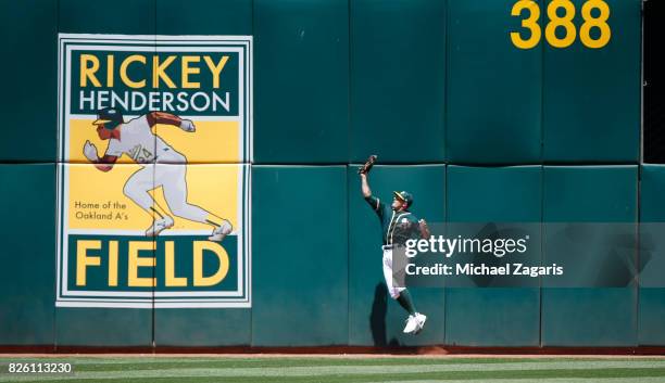 Jaycob Brugman of the Oakland Athletics makes a catch up against the wall during the game against the Cleveland Indians at the Oakland Alameda...