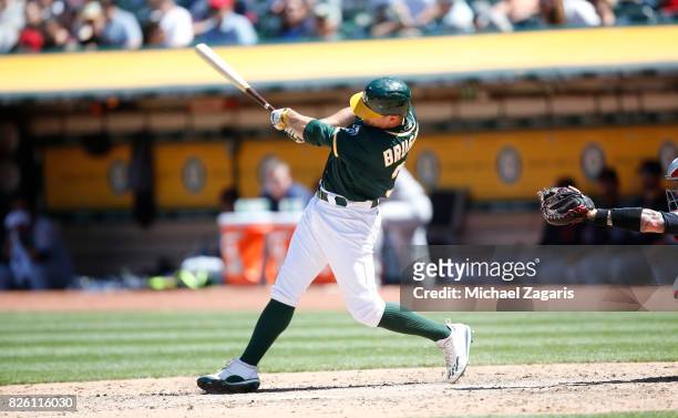 Jaycob Brugman of the Oakland Athletics bats during the game against the Cleveland Indians at the Oakland Alameda Coliseum on July 16, 2017 in...