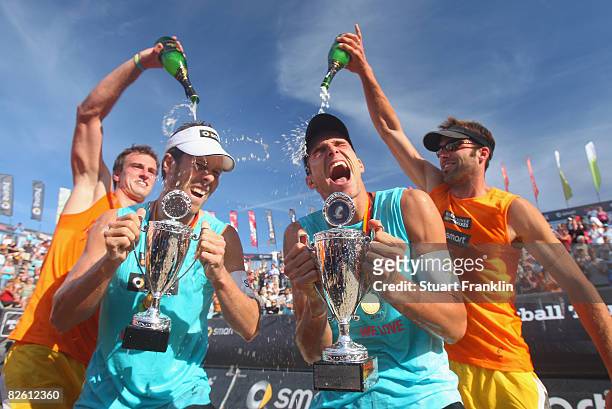 David Klemperer and Eric Koreng celebrate with Florian Ludike and Kjell Schnieder after winning the final match against Julius Brink and Christoph...