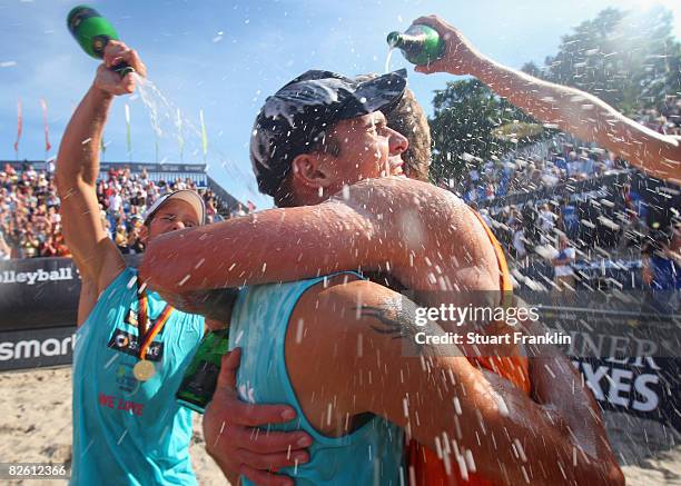 David Klemperer and Eric Koreng celebrate with Florian Ludike and Kjell Schnieder after winning the final match against Julius Brink and Christoph...