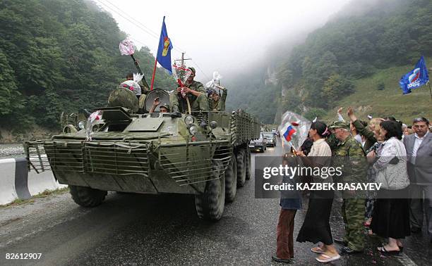 North Ossetian people welcome Russian soldiers as they leave South Ossetia at the North-South Ossetia border, some 60 km outside Vladikavkaz, on...