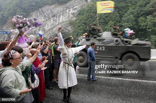 North Ossetian people celebrate as they welcome Russian soldiers as they leave South Ossetia at the North-South Ossetia border some 60 km outside...