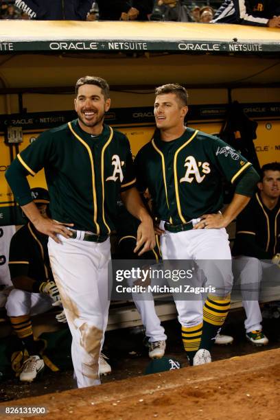 Matt Joyce and Jaycob Brugman of the Oakland Athletics stand on the dugout during the game against the Tampa Bay Rays at the Oakland Alameda Coliseum...