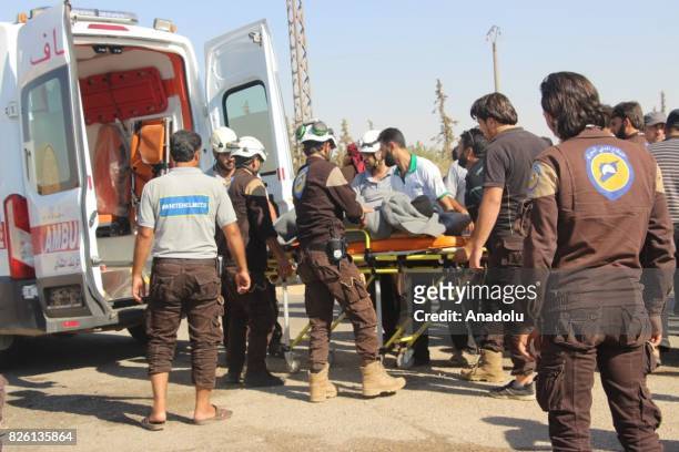 First group of Syrian refugees get off an ambulance, after a cease-fire announced between Hezbollah and Ahrar al-Sham, in Idlib, Syria on August 03,...