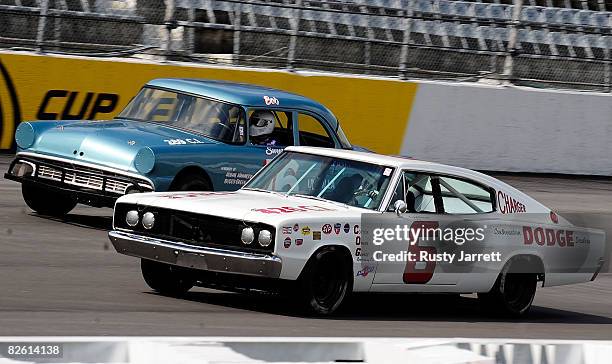 Vintage stock cars run side by each down the front straight during the Darlington Vintage Racing Festival at Darlington Raceway on August 31, 2008 in...
