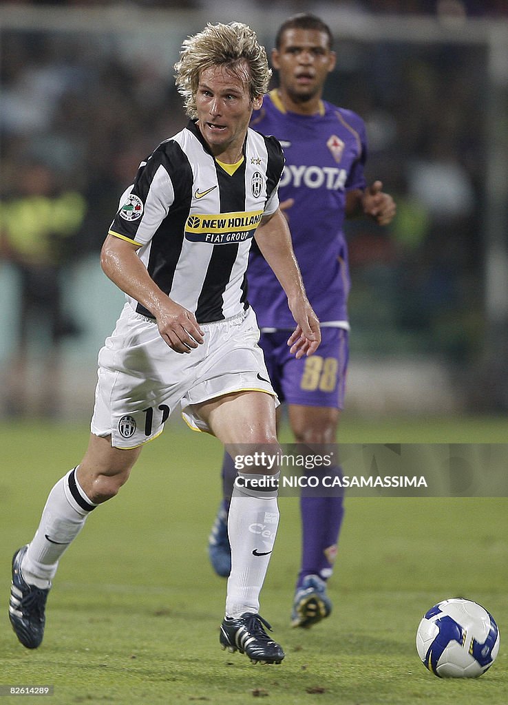 Juventus' Pavel Nedved runs the ball aga