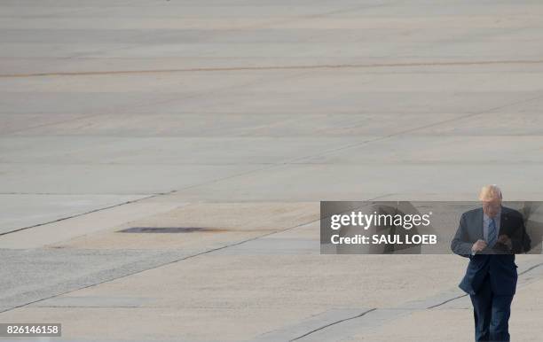 President Donald Trump walks to Air Force One prior to departure from Andrews Air Force Base in Maryland, August 3 as Trump travels to a rally in...