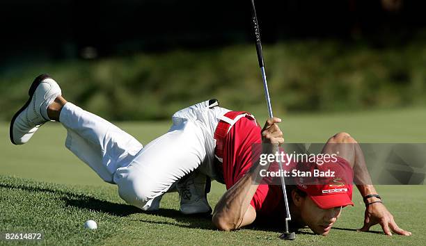 Camilo Villegas of Columbia lowers himself to the 18th green to check his putt during the third round of the Deutsche Bank Championship held at TPC...