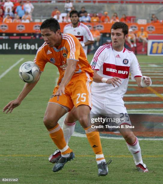 Brian Ching of the Houston Dynamo keeps the ball away from Gonzalo Segares of the Chicago Fire on August 31, 2008 at Robertson Stadium in Houston,...