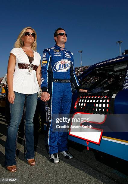 Kurt Busch, driver of the Miller Lite Dodge, and wife Eva, stand on the grid during the national anthem for the NASCAR Sprint Cup Series Pepsi 500 at...