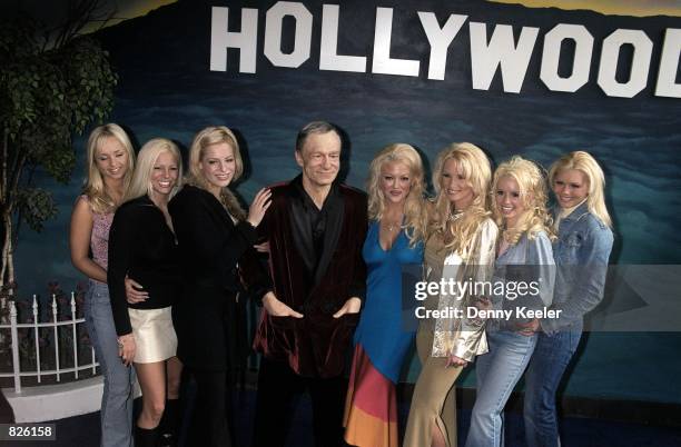 Playboy playmates stand next to a Hugh M. Hefner likeness in wax, outside the Hollywood Wax Museum February 20, 2001 in Hollywood, CA. The event was...