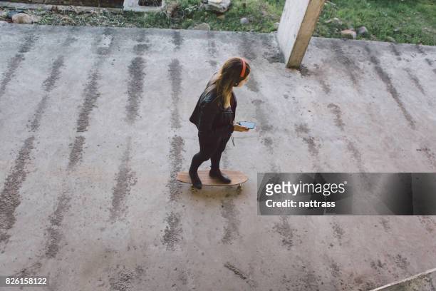 teenage girl skating with music - gangster girl stock pictures, royalty-free photos & images