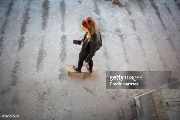 teenage girl skating with her music - gangster girl stock pictures, royalty-free photos & images