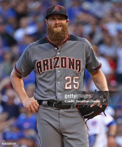 Archie Bradley of the Arizona Diamondbacks reacts after giving up a two run single in the 7th inning to Willson Contreras of the Chicago Cubs at...