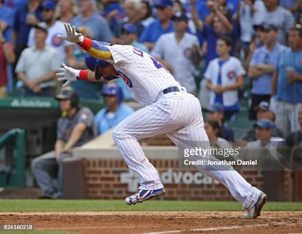 Willson Contreras of the Chicago Cubs celebrates as he runs to first base after hitting a two run single in the 7th inning against the Arizona...