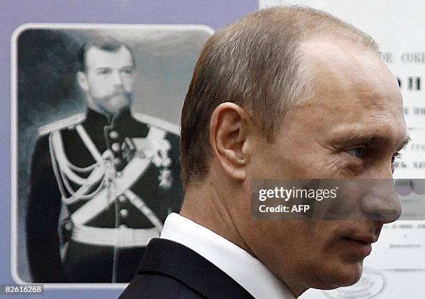 Russian Prime Minister Vladimir Putin stands near a portrait of a Russian Tsar during a visit to a museum at Far Eastern State University in...