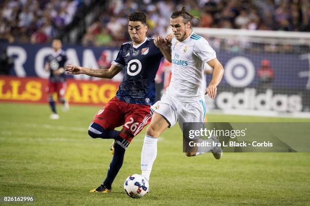 Gareth Bale of Real Madrid tries to keep off the pressure from Miguel Almiron of United States during the MLS All-Star match between the MLS...