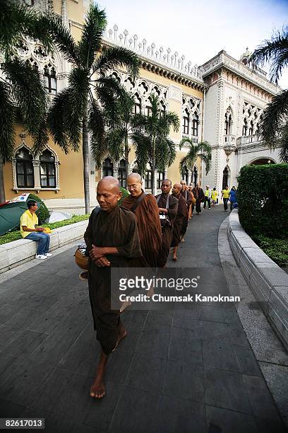 Buddhist monks walk inside the compound of the Government House on September 1 in Bangkok, Thailand. Prime Minister Samak Sundaravej continues to...