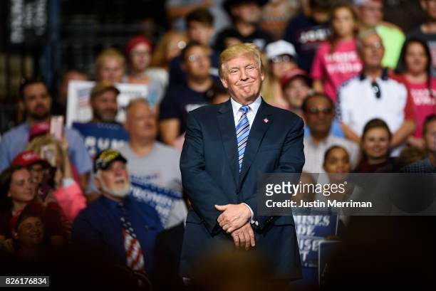 President Donald J. Trump listens as the crowd cheers at a campaign rally at the Big Sandy Superstore Arena on August 3, 2017 in Huntington, West...